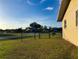 Spacious fenced backyard with lush grass, offering privacy and a tranquil outdoor space at 389 Millport Nw St, Port Charlotte, FL 33948