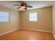 Empty bedroom with wood floors and two windows providing natural light at 389 Millport Nw St, Port Charlotte, FL 33948