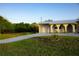 Charming home with a paved driveway, metal roof and well-manicured lawn at 389 Millport Nw St, Port Charlotte, FL 33948