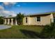 Attractive house with a desert xeriscape style landscape and stucco exterior at 389 Millport Nw St, Port Charlotte, FL 33948
