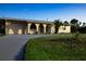 Charming home featuring a large, paved driveway and a well-manicured lawn at 389 Millport Nw St, Port Charlotte, FL 33948