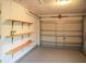 Clean garage interior with overhead door, shelving, and ample space for parking at 389 Millport Nw St, Port Charlotte, FL 33948