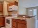 Kitchen with white appliances, modern countertops, and wood cabinets at 389 Millport Nw St, Port Charlotte, FL 33948
