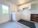 Functional laundry room featuring modern washer/dryer, utility sink, and storage solutions at 389 Millport Nw St, Port Charlotte, FL 33948