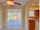 Open-concept living space with tile floors, ceiling fan, and adjacent modern kitchen with backyard view at 389 Millport Nw St, Port Charlotte, FL 33948