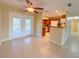 Open-concept living space with tile floors, ceiling fan, and adjacent modern kitchen at 389 Millport Nw St, Port Charlotte, FL 33948
