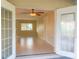 View from the porch into the bright living room with tile flooring and a ceiling fan at 389 Millport Nw St, Port Charlotte, FL 33948