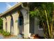 Close-up of arched front porch featuring updated beige paint, landscaping, and modern front door at 389 Millport Nw St, Port Charlotte, FL 33948