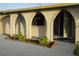 Charming house with a paved driveway, front arched porch and desert xeriscape landscaping at 389 Millport Nw St, Port Charlotte, FL 33948