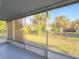 Screened porch area overlooking the fenced in backyard with mature trees at 389 Millport Nw St, Port Charlotte, FL 33948