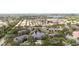 Aerial view showcases community nestled amidst lush greenery, lakes, and tranquil water features at 4325 46Th W Ave # 104, Bradenton, FL 34210