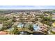 Aerial view features community pools, tennis courts, lakes, winding waterways, and mature landscaping at 4325 46Th W Ave # 104, Bradenton, FL 34210