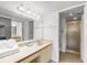 Bathroom featuring dual sink vanity and walk-in shower at 4325 46Th W Ave # 104, Bradenton, FL 34210