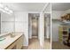 Bathroom featuring dual sink vanity, walk-in shower, and closet at 4325 46Th W Ave # 104, Bradenton, FL 34210