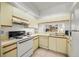 Well-lit kitchen featuring a white oven, ample counter space, and a convenient pass-through window at 4325 46Th W Ave # 104, Bradenton, FL 34210
