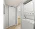 Bright laundry area featuring stacked washer and dryer, located near a closet at 4325 46Th W Ave # 104, Bradenton, FL 34210
