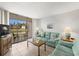 Cozy living room with water view featuring comfortable seating and sliding glass doors to patio at 4325 46Th W Ave # 104, Bradenton, FL 34210
