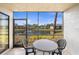 Relaxing screened patio with table and chairs overlooking a serene lake view at 4325 46Th W Ave # 104, Bradenton, FL 34210