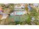 Aerial view of the community pool and tennis courts surrounded by lush landscaping and trees at 4325 46Th W Ave # 104, Bradenton, FL 34210