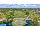 Expansive aerial view of a golf course with water features, lush greenery, and serene landscaping at 4487 Glebe Farm Rd, Sarasota, FL 34235