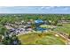 Aerial shot of a country club featuring a golf course, pond, clubhouse, and golf cart parking at 4487 Glebe Farm Rd, Sarasota, FL 34235
