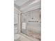 Bathroom showcasing a glass-enclosed shower with stylish tiling and accessible features at 4487 Glebe Farm Rd, Sarasota, FL 34235