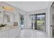 Bathroom featuring white tile flooring, a sink with vanity, golf course views and access to the pool at 4487 Glebe Farm Rd, Sarasota, FL 34235