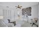 Bedroom featuring a zebra painting, a ceiling fan, white furniture, and bright, neutral walls and carpeting at 4487 Glebe Farm Rd, Sarasota, FL 34235