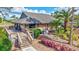 Charming exterior view of the clubhouse featuring a wood facade, landscaped gardens, and a welcoming entrance at 4487 Glebe Farm Rd, Sarasota, FL 34235