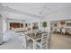 Open-concept dining area featuring stylish table set, seamlessly connecting to living spaces, creating an inviting atmosphere at 4487 Glebe Farm Rd, Sarasota, FL 34235