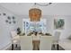 Bright dining area featuring a stylish woven chandelier, seating for six, and views of the backyard pool at 4487 Glebe Farm Rd, Sarasota, FL 34235