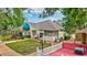 Attractive commercial building with a blue awning, surrounded by lush landscaping and a charming white picket fence at 4487 Glebe Farm Rd, Sarasota, FL 34235