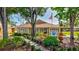 Commercial building with meticulously landscaped grounds, featuring an American flag and clear signage at 4487 Glebe Farm Rd, Sarasota, FL 34235