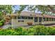 Well-maintained commercial building featuring large windows, a comfortable bench, and professional signage at 4487 Glebe Farm Rd, Sarasota, FL 34235