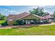 Commercial building with mature trees, ample signage, and lush landscaping, providing a professional and inviting atmosphere at 4487 Glebe Farm Rd, Sarasota, FL 34235