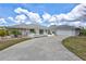 Spacious home exterior features a circular driveway, attached garage and manicured landscaping, enhancing the property's curb appeal at 4487 Glebe Farm Rd, Sarasota, FL 34235