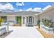 Charming front entrance with decorative glass door, light-blue trim and well-maintained landscaping, creating a welcoming curb appeal at 4487 Glebe Farm Rd, Sarasota, FL 34235