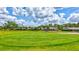 Scenic view of a meticulously maintained golf course with vibrant green grass under a bright sky at 4487 Glebe Farm Rd, Sarasota, FL 34235