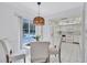 Charming breakfast nook with sliding door access to pool, attached to a bright kitchen with white appliances at 4487 Glebe Farm Rd, Sarasota, FL 34235