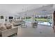Bright living room with golf course views, neutral furniture, and ample natural light, perfect for relaxation and entertainment at 4487 Glebe Farm Rd, Sarasota, FL 34235
