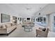 Large living room with cozy seating, bright decor, pool view access, and seamless indoor-outdoor transition at 4487 Glebe Farm Rd, Sarasota, FL 34235