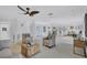 Bright living room with comfortable seating, stylish decor, and ceiling fan in an open-concept layout at 4487 Glebe Farm Rd, Sarasota, FL 34235