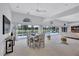 Large dining and living space with lots of light, open concept, and pool views at 4487 Glebe Farm Rd, Sarasota, FL 34235
