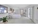 Bright main bedroom with a ceiling fan, a large bed, ample natural light, and access to an outdoor area at 4487 Glebe Farm Rd, Sarasota, FL 34235