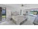 Spacious main bedroom features white furniture, a comfortable seating area, and outdoor access at 4487 Glebe Farm Rd, Sarasota, FL 34235