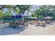 Outdoor patio with multiple tables and chairs arranged on a wooden deck, perfect for dining and social gatherings at 4487 Glebe Farm Rd, Sarasota, FL 34235