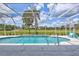 Inviting pool area with sparkling blue water, screened enclosure, and scenic golf course views, ideal for relaxation and recreation at 4487 Glebe Farm Rd, Sarasota, FL 34235
