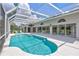 Screened in pool with crystal clear water, surrounding patio, and partial view of the house at 4487 Glebe Farm Rd, Sarasota, FL 34235