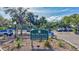 Entrance to The Meadows Country Club Racquet Club featuring lush landscaping and well-maintained grounds at 4487 Glebe Farm Rd, Sarasota, FL 34235