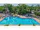 Inviting swimming pool with lounge chairs, umbrellas, and manicured landscaping, creating a resort-like experience at 4487 Glebe Farm Rd, Sarasota, FL 34235